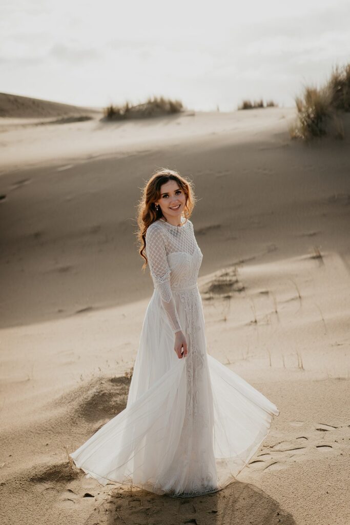 Bride wearing white lace wedding dress for Oregon sand dunes elopement