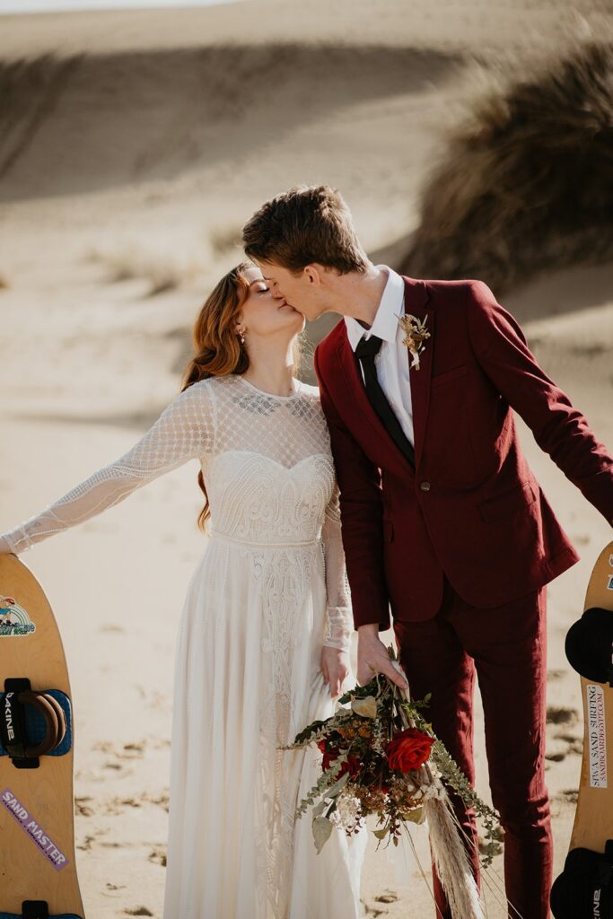 Couple kissing during elopement photos on the Oregon sand dunes