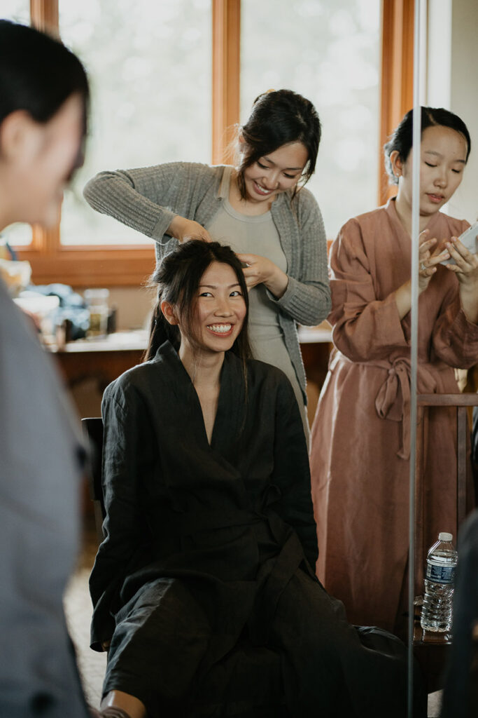 Judith smiling wide while getting her hair done. 
