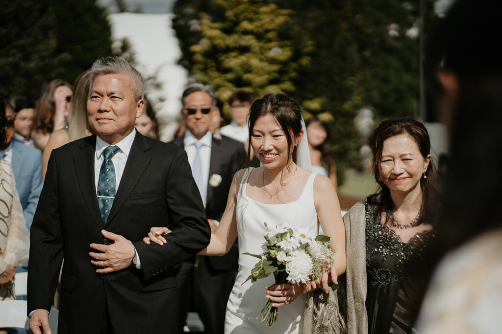 Judith walking with her Dad and Mom down the isle. 