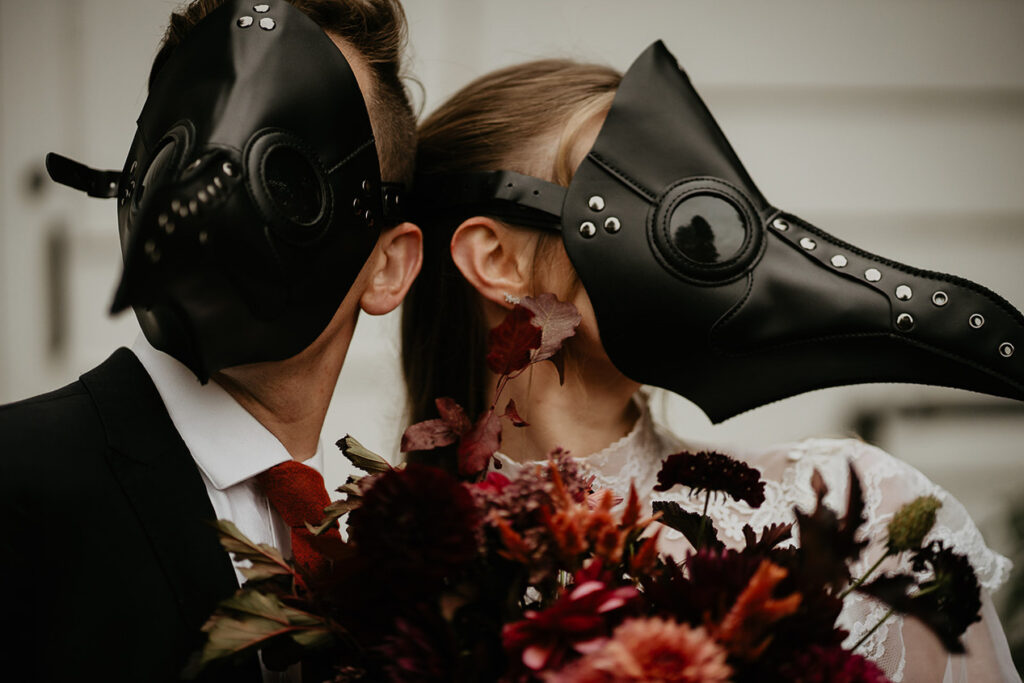 A close up of the bird masks a couple is wearing during their elopement in Discovery Park. 