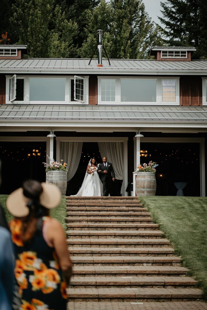Bride and father enter their outdoor wedding ceremony at Gorge Crest Vineyards