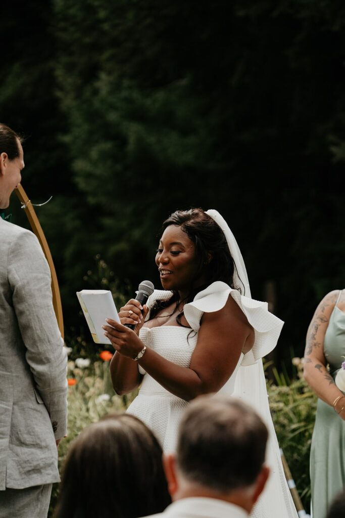 Bride reads personal vows during Gorge Crest Vineyards wedding ceremony