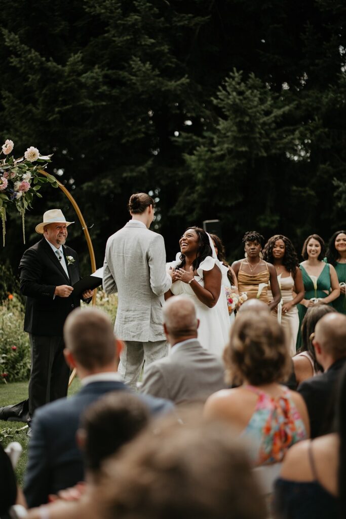 Bride laughs during outdoor wedding reception at Gorge Crest Vineyards