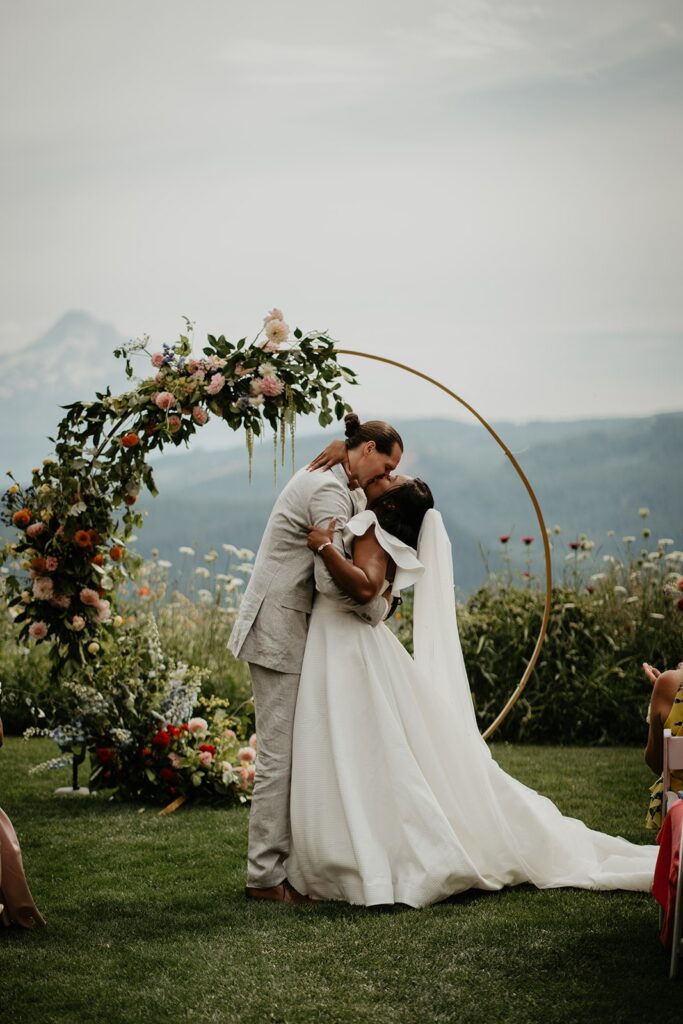 Bride and groom kiss during their Gorge Crest Vineyards wedding