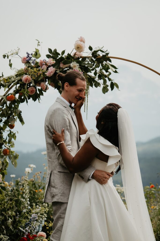 Bride and groom embrace after their outdoor wedding ceremony at Gorge Crest Vineyards