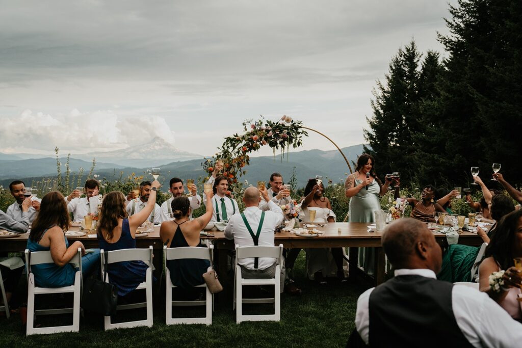 Guests toast during Gorge Crest Vineyards wedding reception