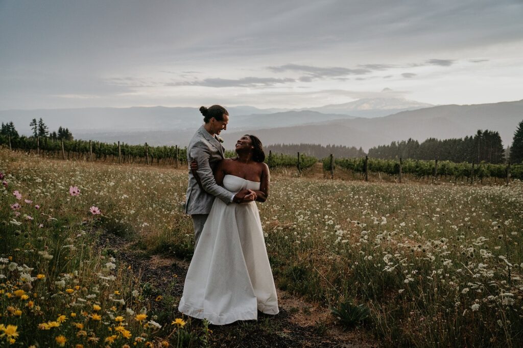 Bride and groom couple photos in a wildflower field at Gorge Crest Vineyards wedding