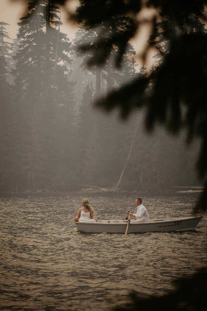 A couple rowing on a smokey Lost Lake. 