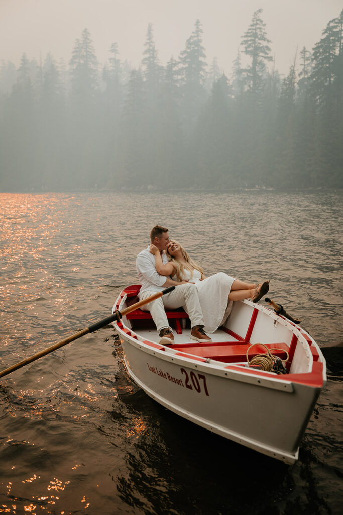 A couple in a row boat embracing each other, floating on Lost Lake in Oregon. 