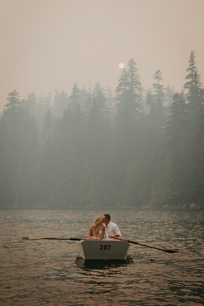 A couple kissing in a row boat on Lost Lake. 