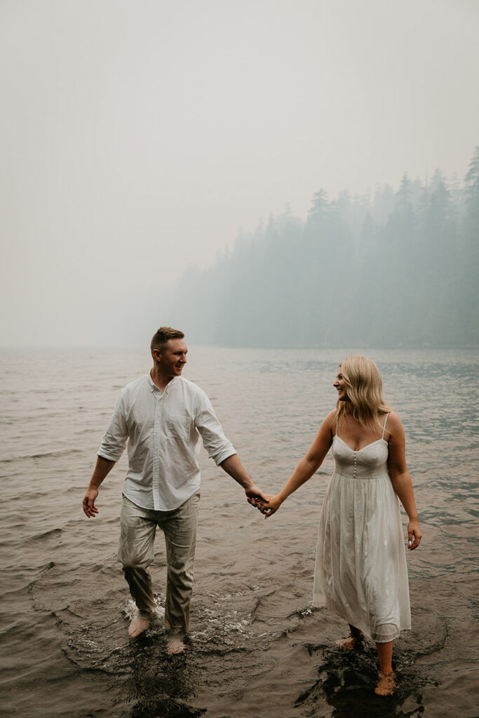 The couple holding hands in lost lake. 