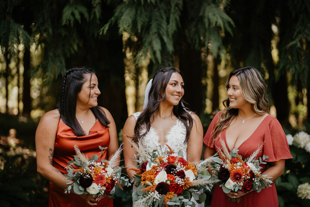 One of the brides smiling with her bridesmaids. 