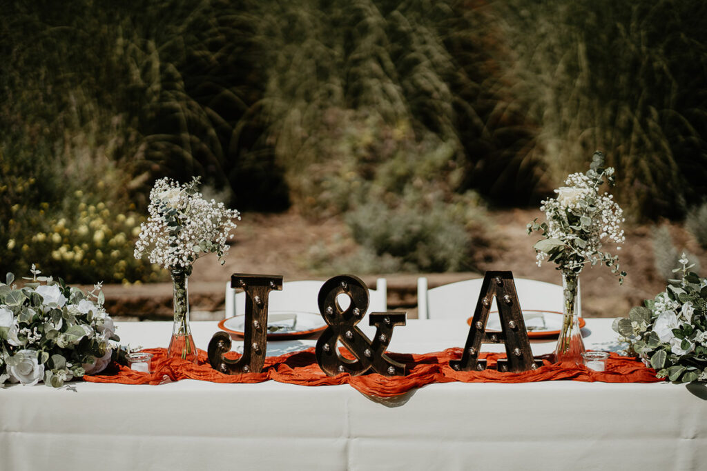Fun table details, including the couple's initials and flowers at CedarVale events. 
