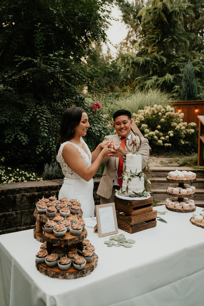 The couple cutting their cake at their CedarVale Events Wedding. 