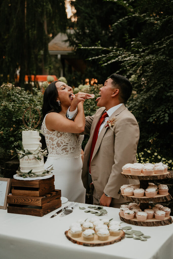 The newlyweds feeding each other cake. 