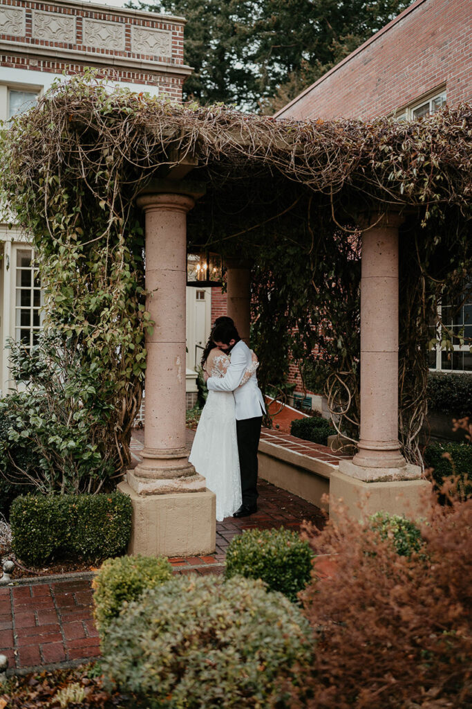 The bride and groom hugging in the Lairmont Manor courtyard. 