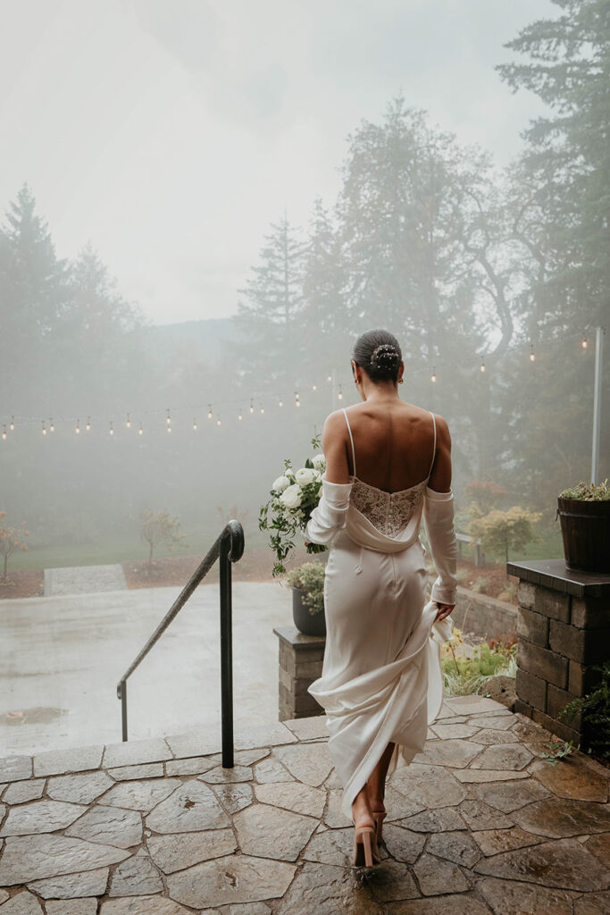 The bride waking out into a misty Rocky Hill Weddings & Events venue. 