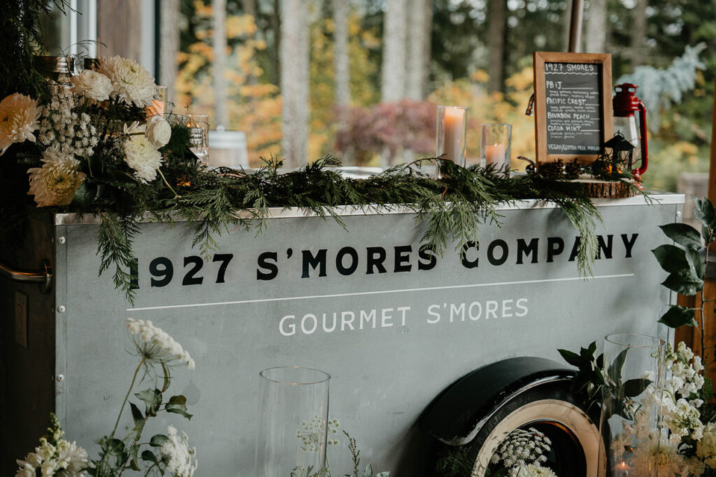 The 1927 s'mores company cart decorated in greenery and white flowers. 