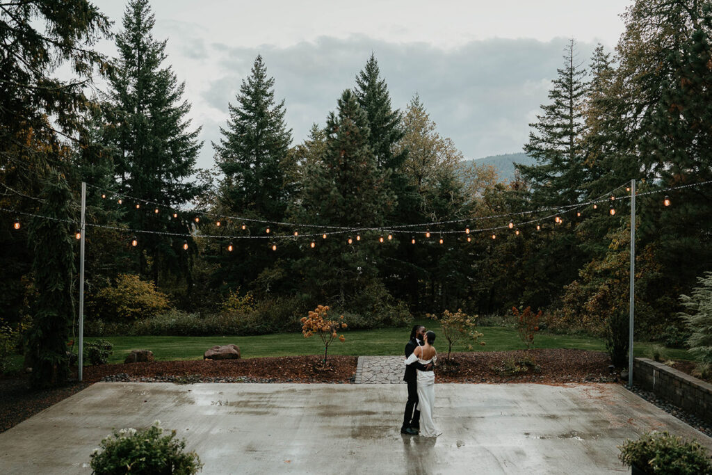 The bride and groom dancing on a slightly damp outdoor dance floor at Rocky Hill Wedding & Events. 