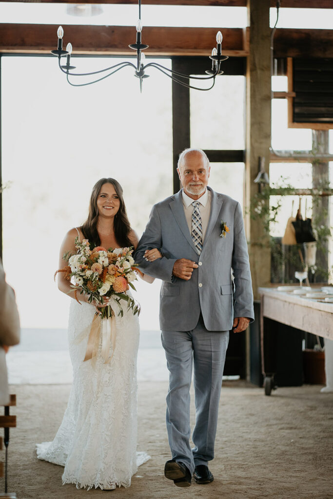 the bride walking down the isle with her dad. 