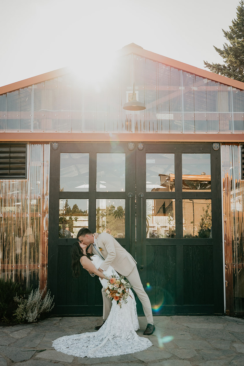 the newlyweds kissing outside Mt Hood Center. 