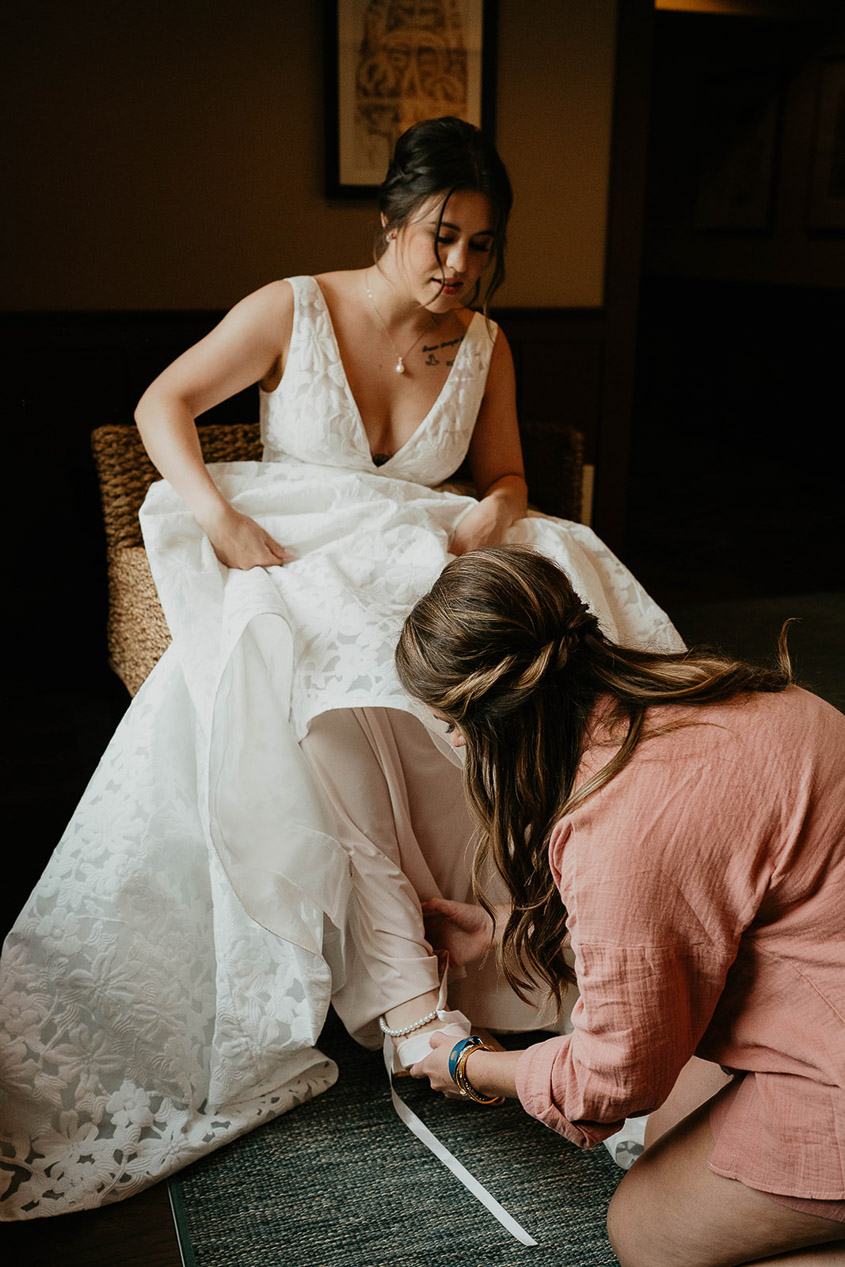 The bride getting dressed for her wedding. 
