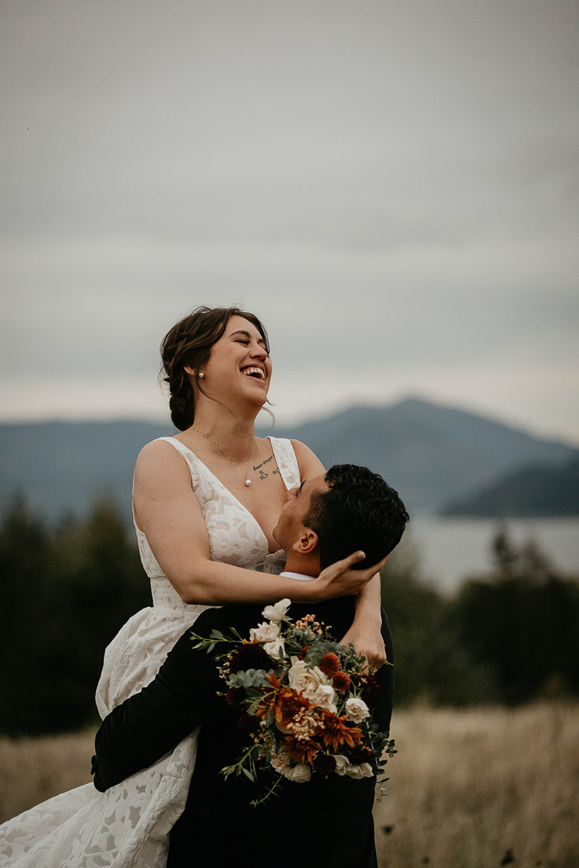a husband carries his wife at Skamania Lodge. 