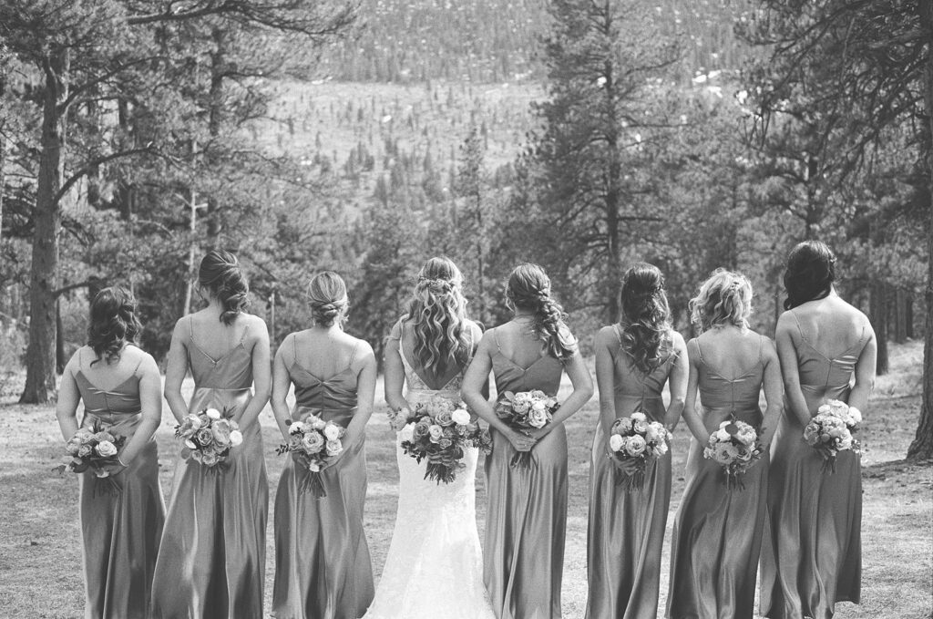 Bride and bridesmaids hold wedding flower bouquets during their film wedding photography session