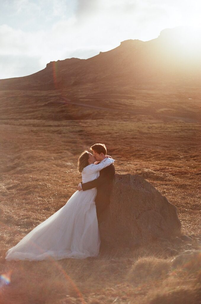 Bride and groom kiss during their wedding film photography session in Iceland