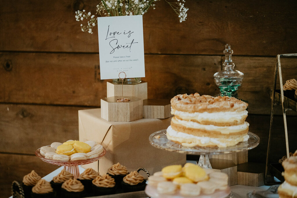 The Abbey Road Farm wedding desert table, complete with cupcakes, macaroons, and cake. 