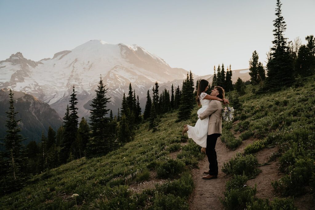 Bride and groom on a mountain trail during their elopement at Mount Rainier in Washington