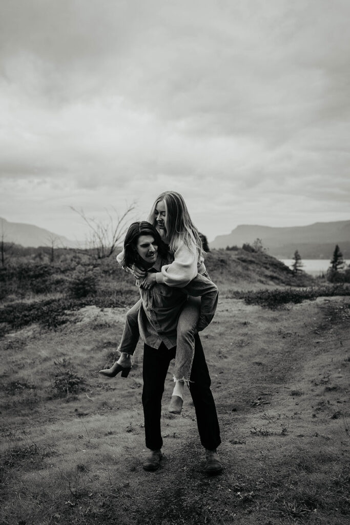 A newly engaged couple holding each other in the Columbia River Gorge.