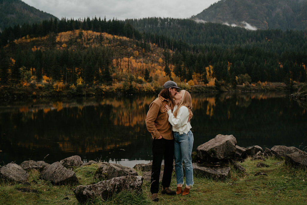 A couple kissing on the riverbank of the Columbia River. 