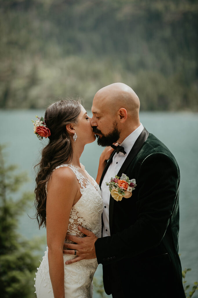 The newlyweds kissing in Glacier National Park. 
