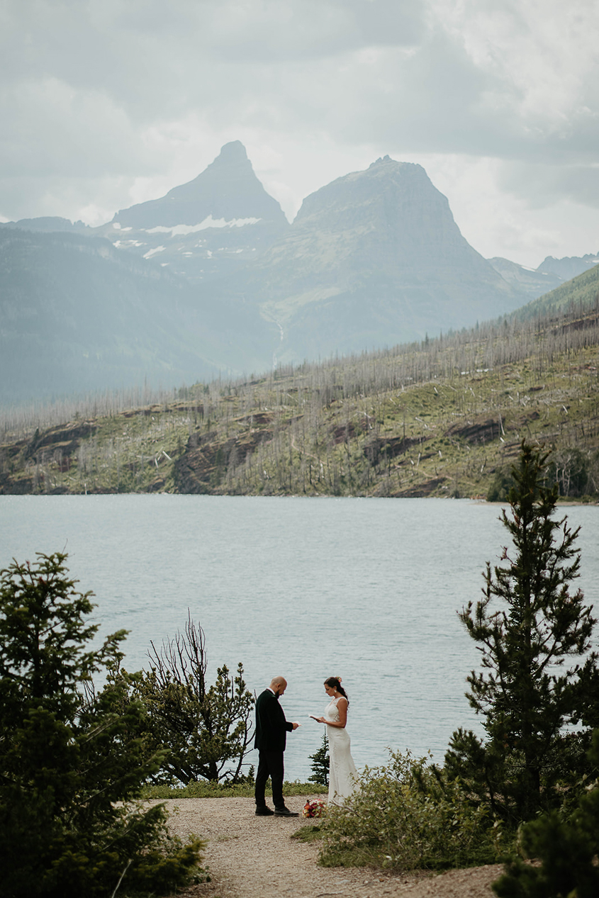 The couple sharing their vows during their Glacier National Park Elopement. 