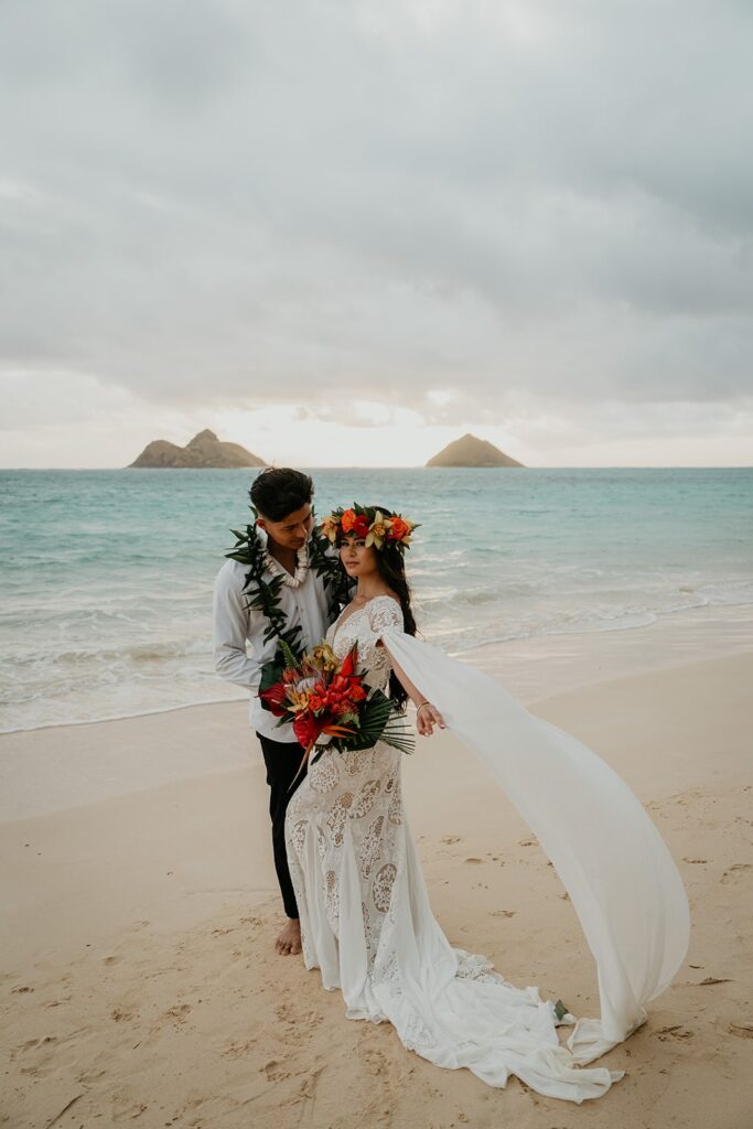 Bride and groom elopement photos on a white sand beach in Oahu