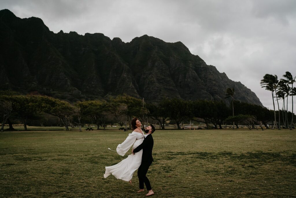 Bride and groom dance in a field during their elopement in Hawaii