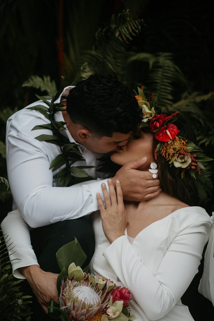 Bride and groom kiss in a rainforest during their Hawaii elopement