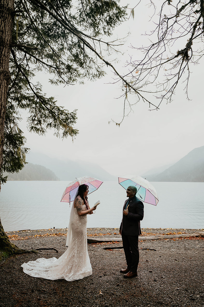 The bride sharing her vows to her groom at Lake Crescent during their elopement 