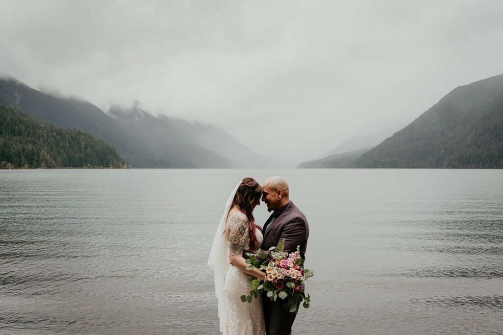 The bride and groom holding each other during their Lake Crescent elopement. 