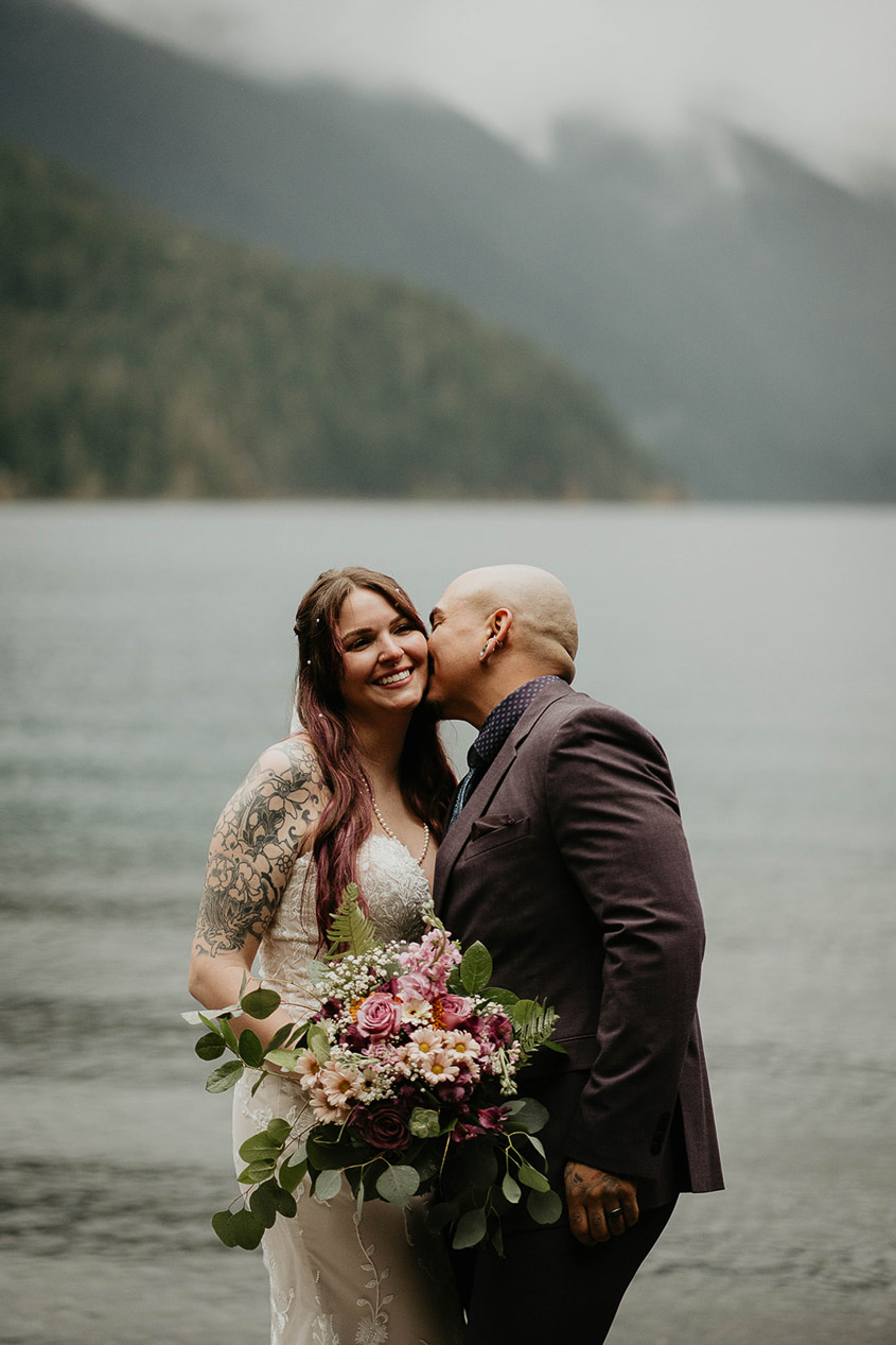 The newlyweds kissing at their Lake Crescent elopement.