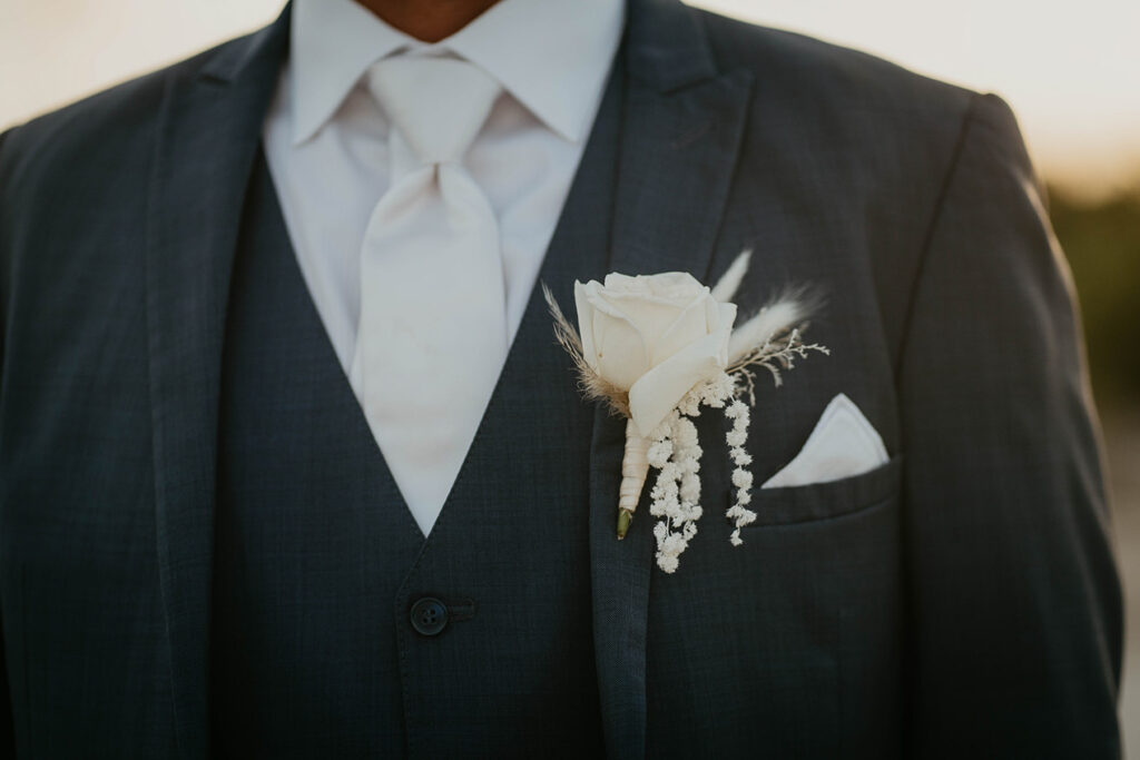 The boutonniere on the groom's lapel.  