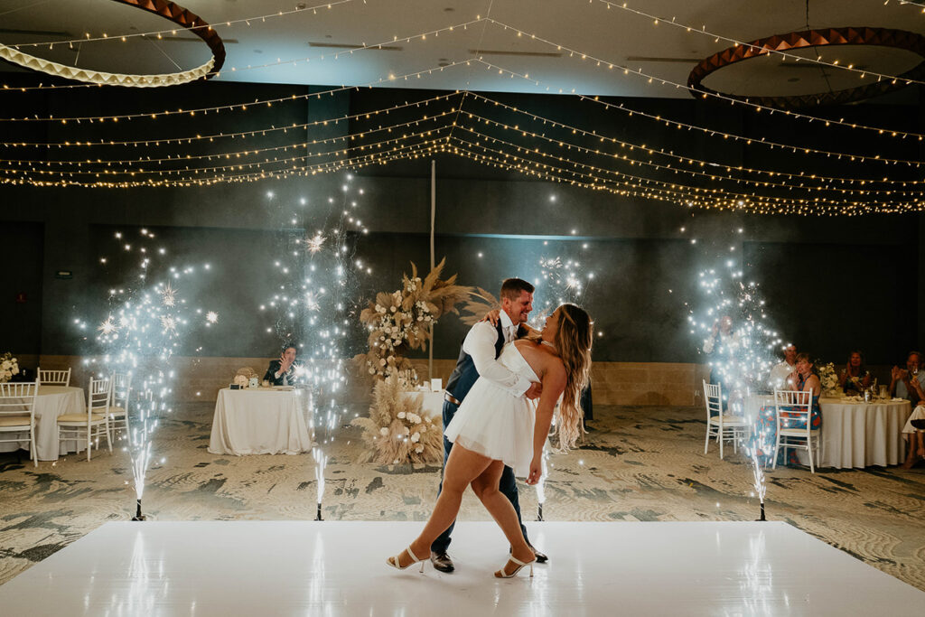 The bride and groom dancing under twinkling lights during their Mexico destination wedding. 