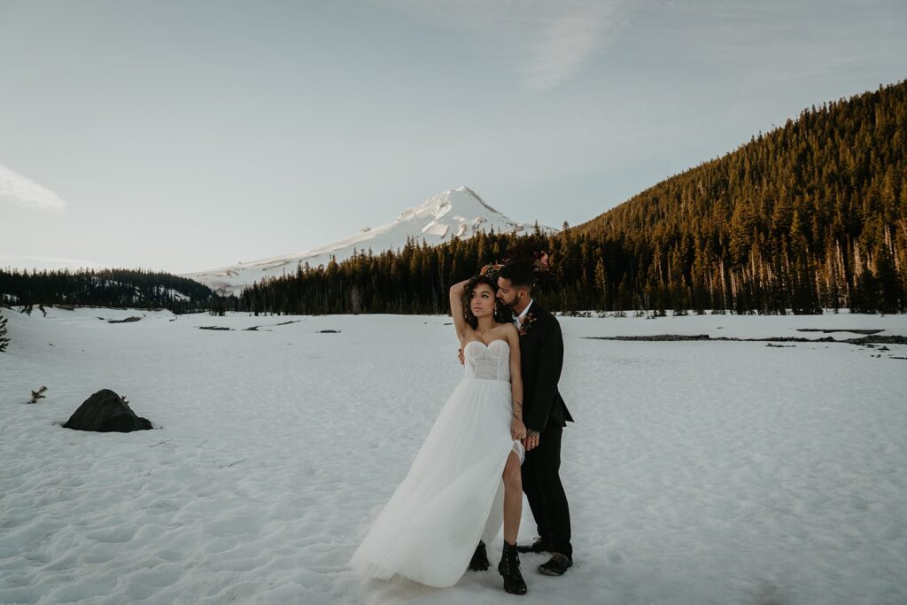 Bride and groom dance in the snow while they elope in the pacific northwest