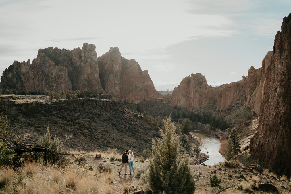 The couple kidding with deep river canyons in the background.