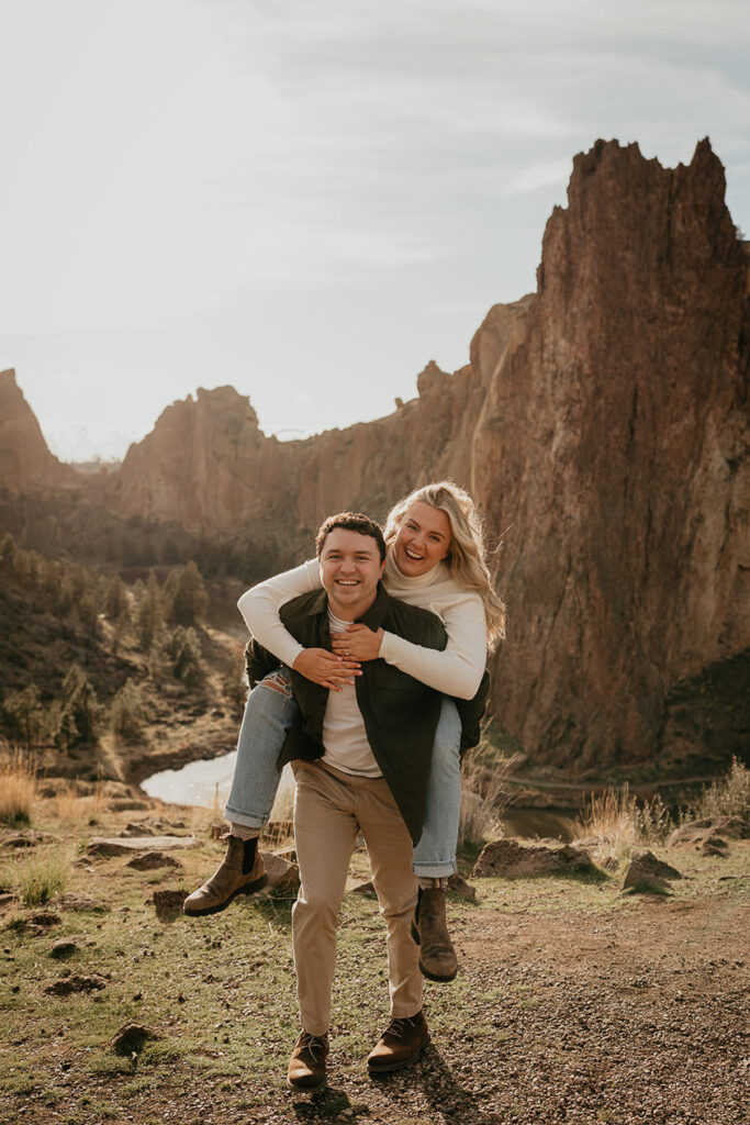 the boyfriend carrying his fiancée during their Smith Rock Engagement session. 