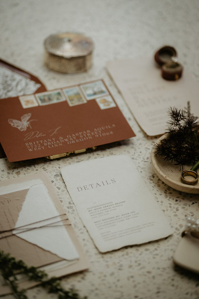 a flat lay including wedding details, and invitation. 