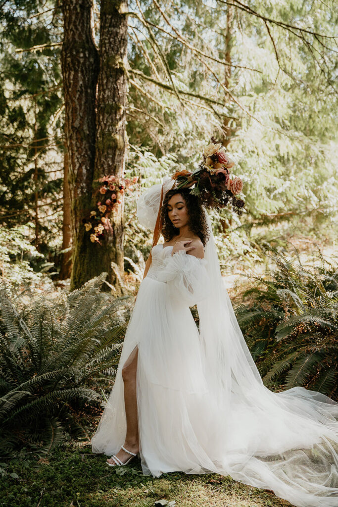 the bride posing under a pine tree. 