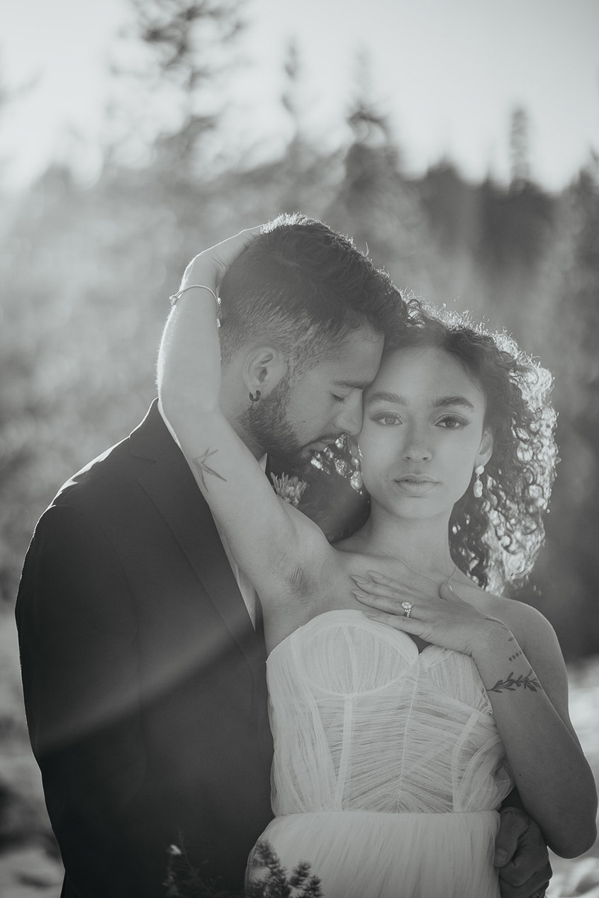 The bride and groom posing with each other.